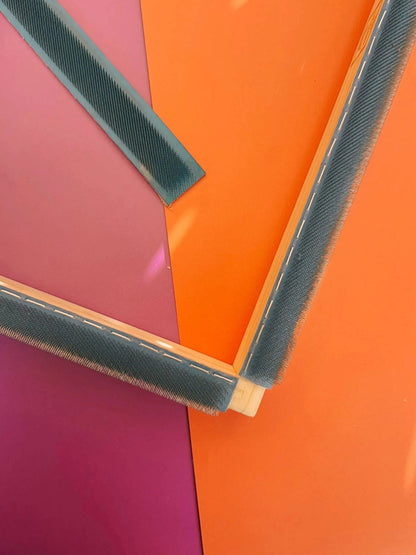 Gripper strips mounted on a punch needle frame