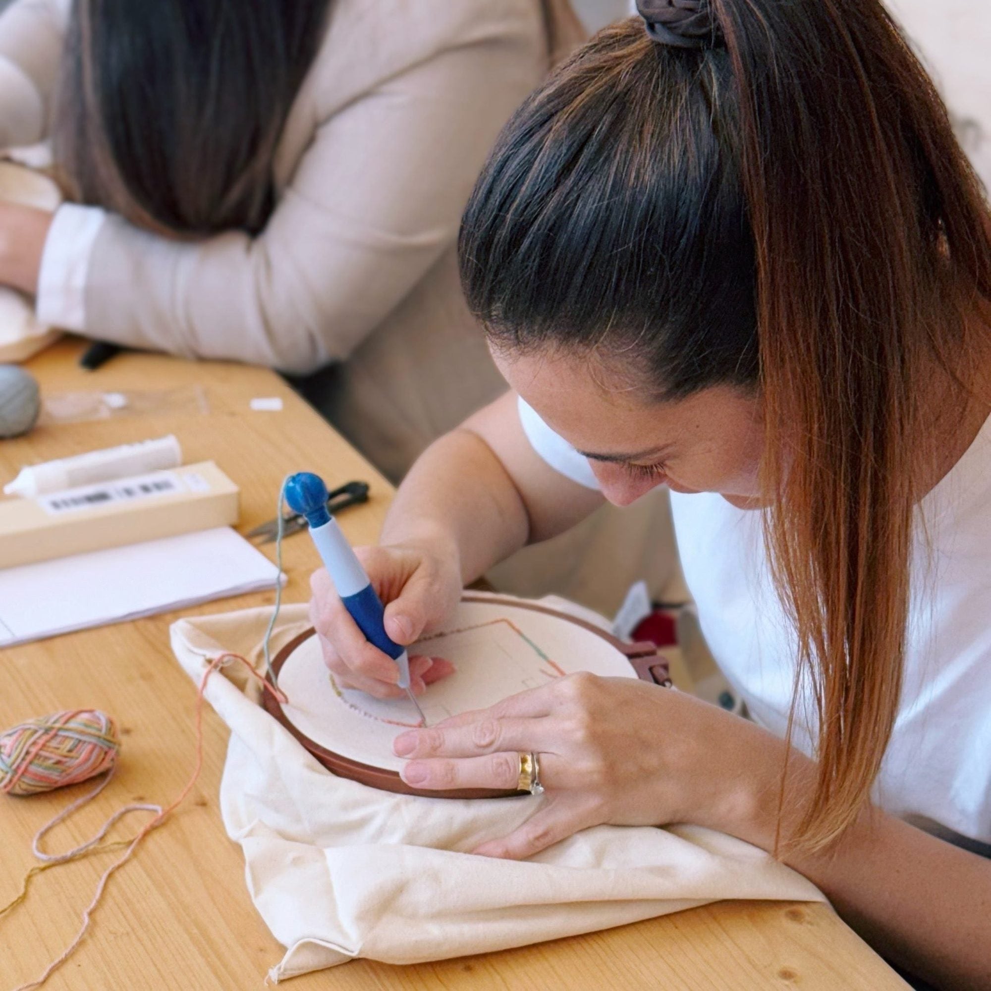 Punch needling a tote bag by hand
