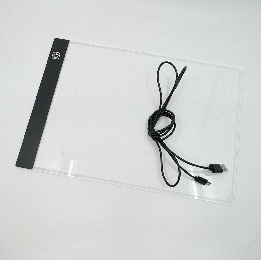 A4 light pad in use tracing a design