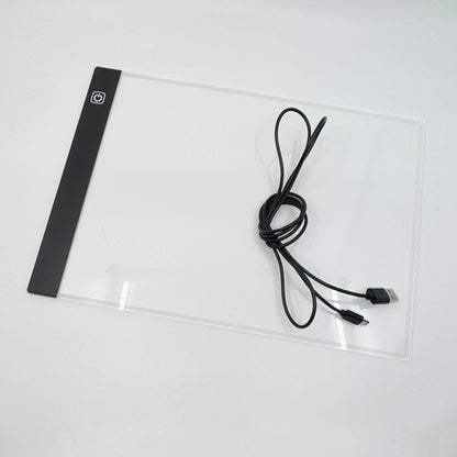 A4 light pad in use tracing a design