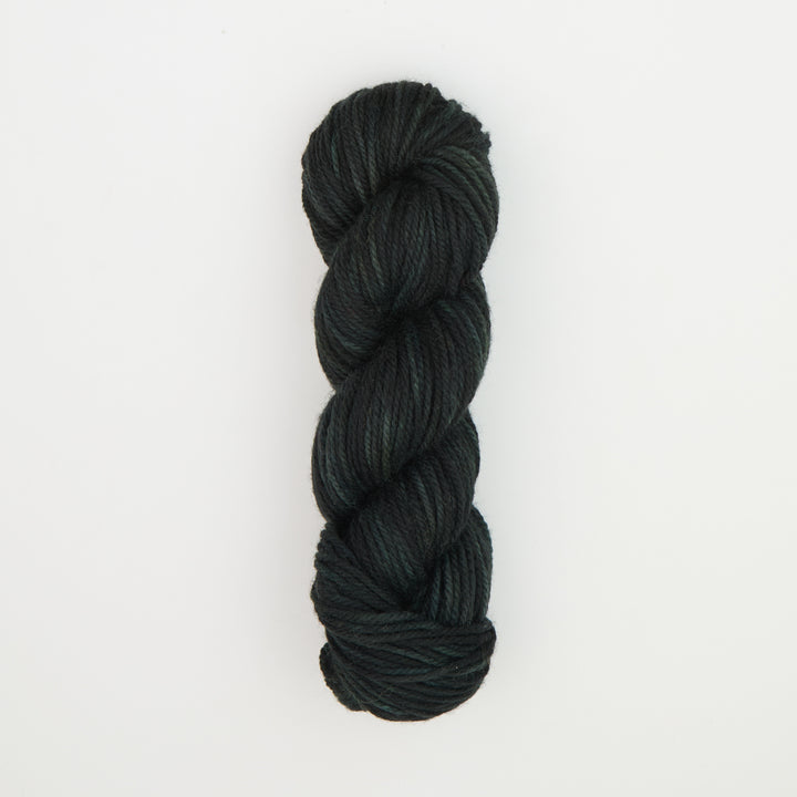 Fine punch needle yarn swatch in Black Green Velvet variegated colours