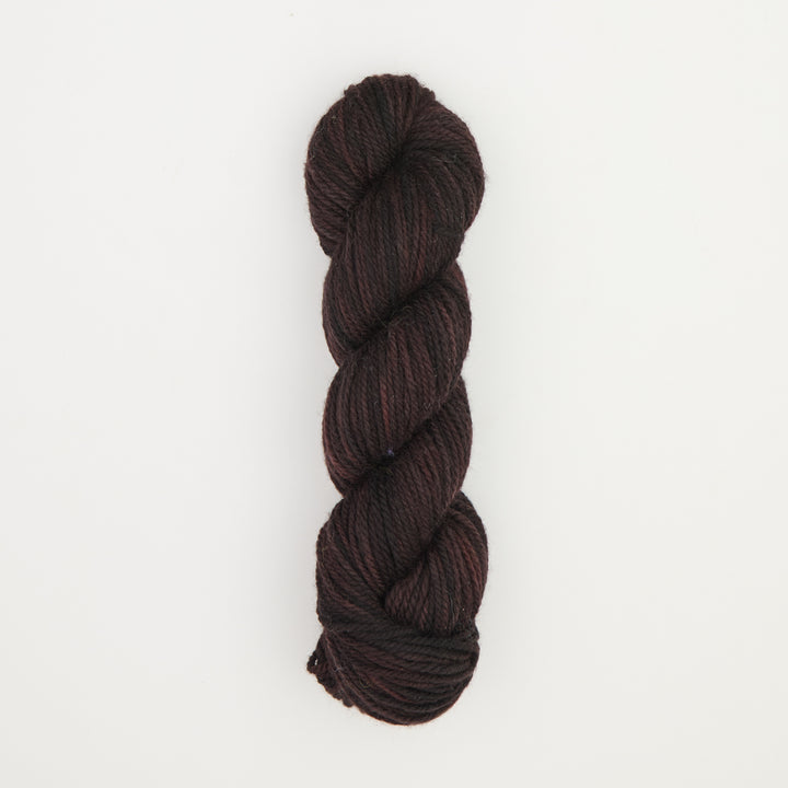 Fine punch needle yarn swatch in Black Hollow variegated colours