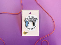 Enamel pin shaped like a tiny tufting machine