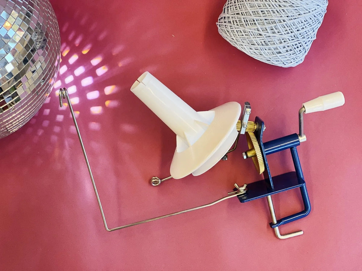 Metal yarn ball winder for tufting